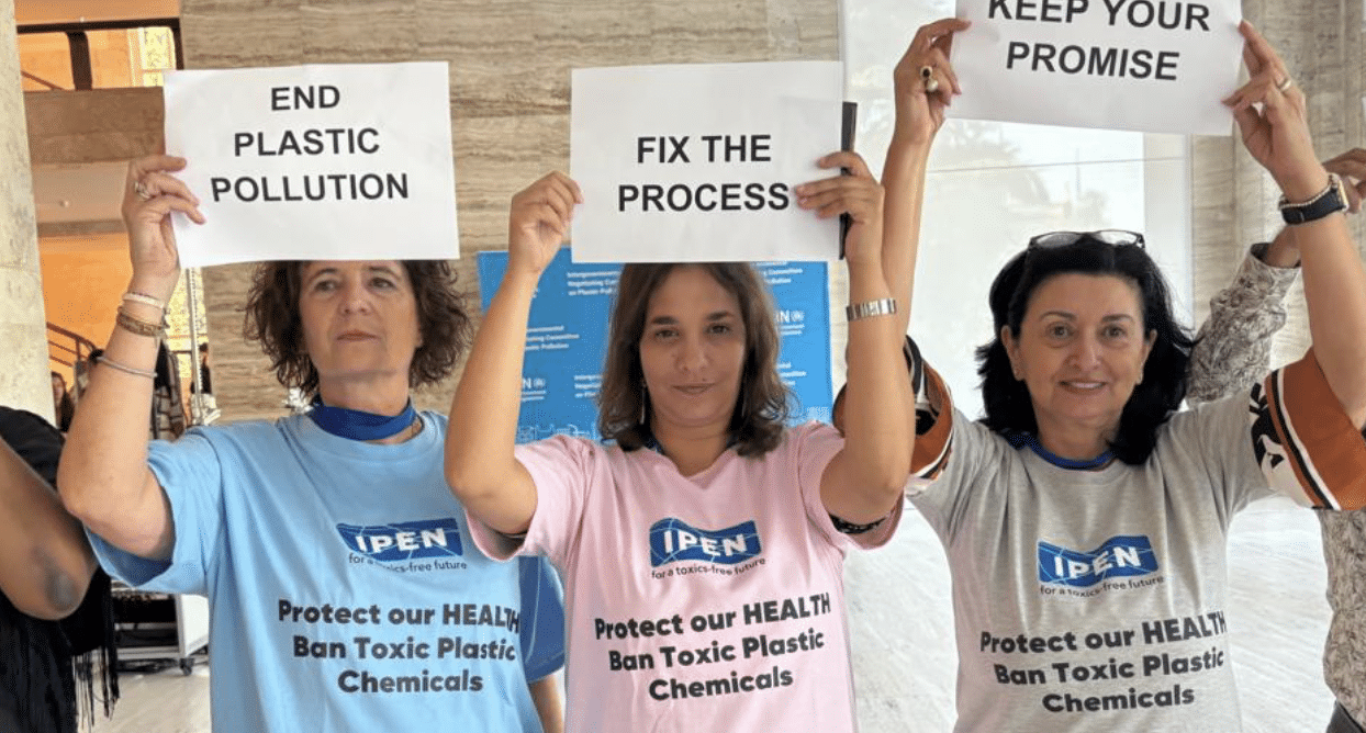 3 IPNers holding up signs at INC5.2